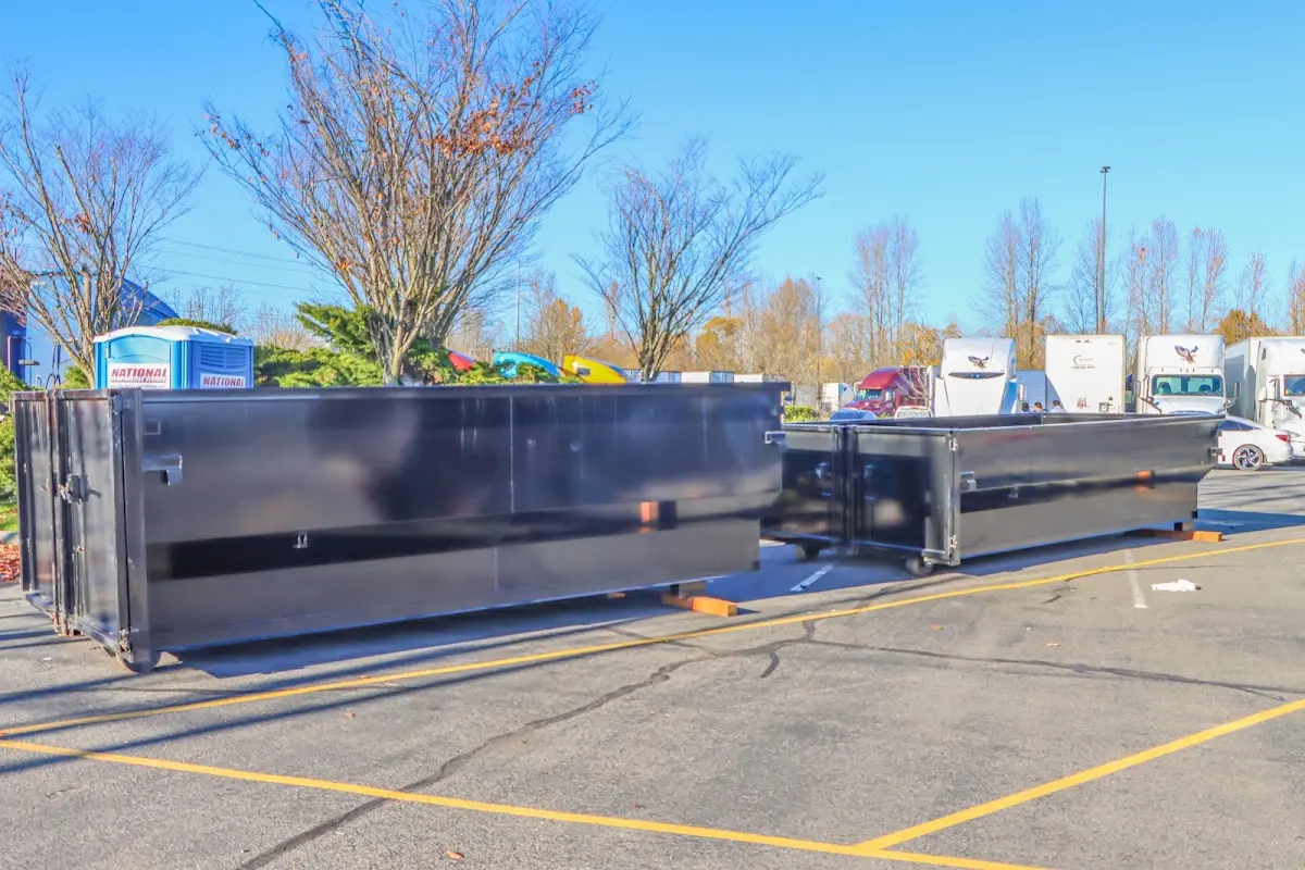 Professional dumpster rental service with roll-off container on residential driveway in Ponchatoula